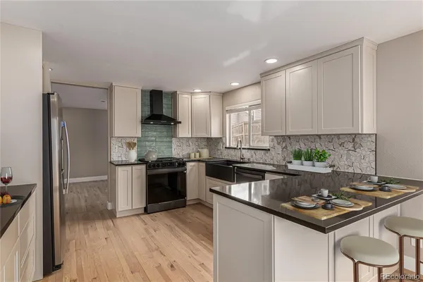 a kitchen with a sink stove top oven and refrigerator