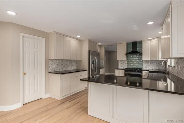 a kitchen with granite countertop a sink and cabinets