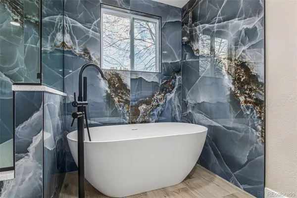 a white bath tub sitting in a bathroom