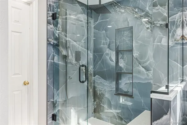 a bathroom with a glass shower door