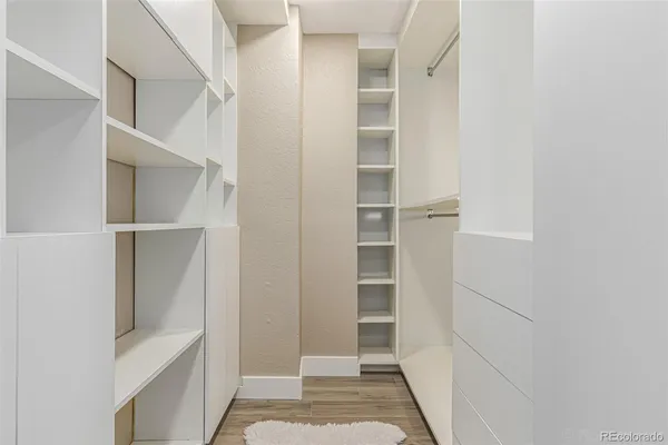 a view of walk in closet with empty racks