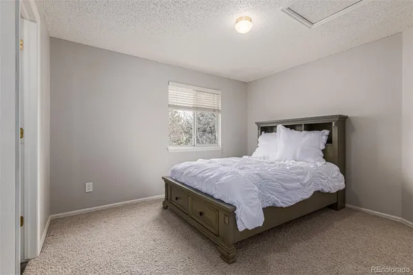 a spacious bedroom with a bed and window