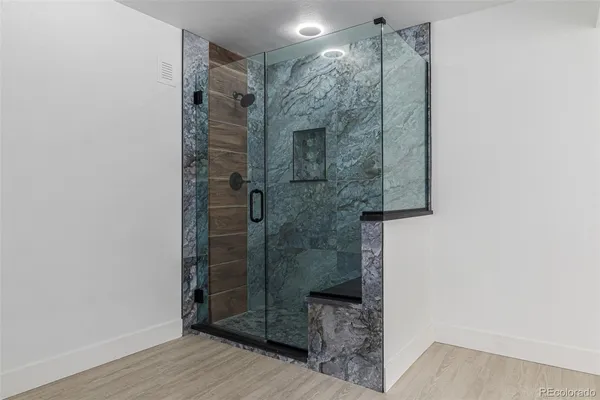 a bathroom with a shower and a sink