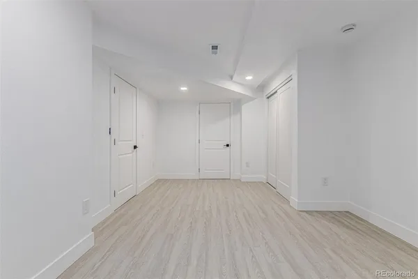 a view of a room with wooden floor