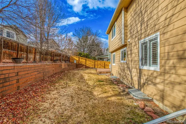 a view of a yard with brick walls