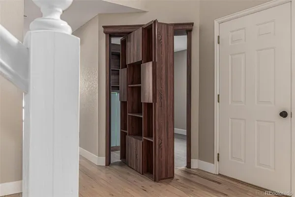 a view of hallway with wooden floor