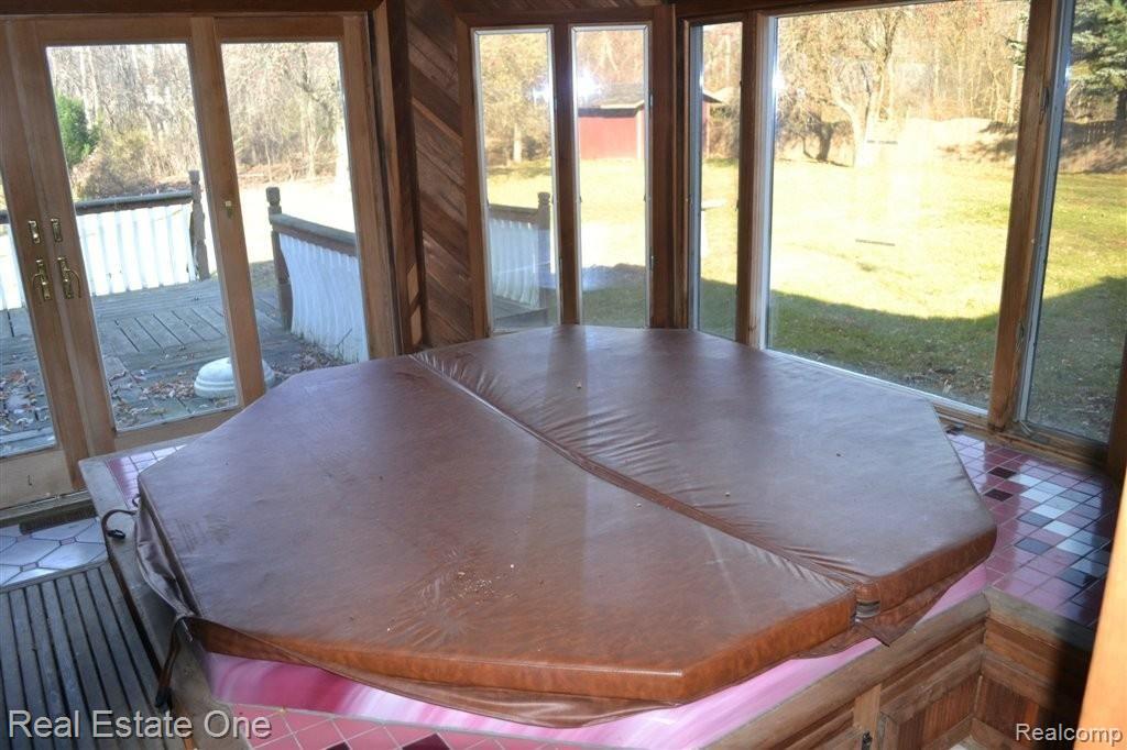 1382 Potomac Drive Rochester, MI 48306 - Photo 13 of 22 Enclosed Sunroom w/ Hot Tub