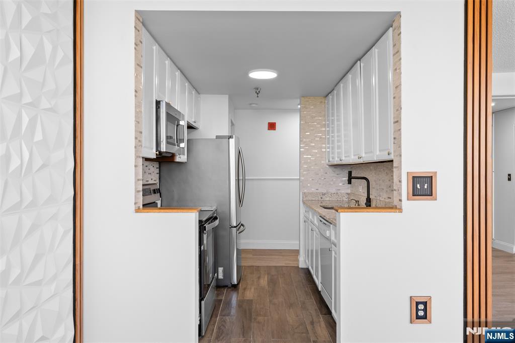 100 Old Palisade Road, Unit 3215 Fort Lee, NJ 07024 - Photo 11 of 43 a kitchen with a refrigerator a sink and dishwasher