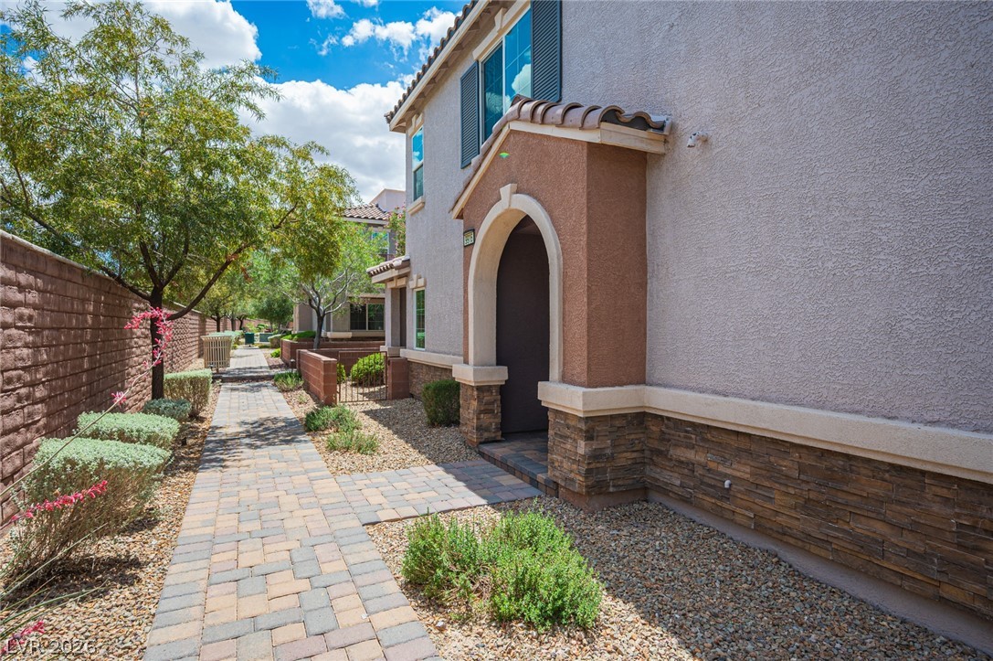 9916 Sable Point Street Las Vegas, NV 89178 - Photo 6 of 73 A welcoming arched entryway and patterned walkway enhance this property's charm.