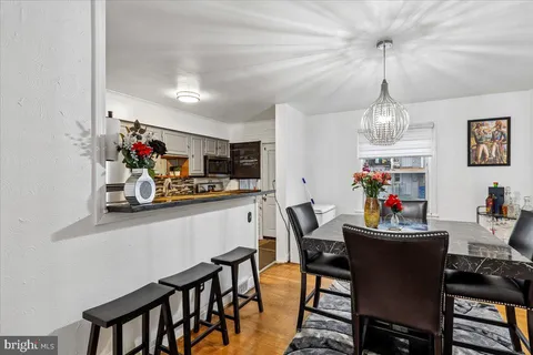 a view of a dining room with furniture and chandelier