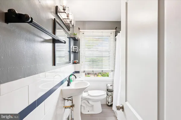 a bathroom with a sink a toilet and a bathtub
