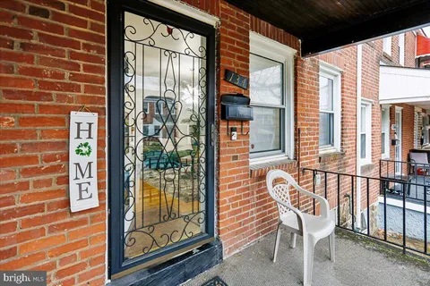 a view of a balcony with a dining table and chairs with outer view
