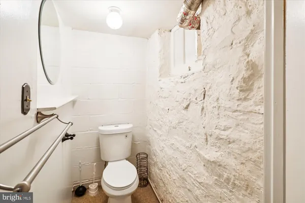 a white toilet sitting next to a shower curtain