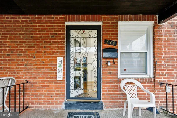 a front view of a house with outdoor seating