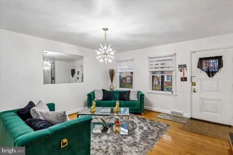 a living room with furniture and a chandelier