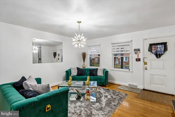a living room with furniture and a chandelier