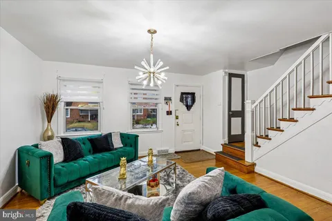 a living room with furniture and a chandelier