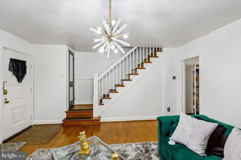 a view of a livingroom with wooden floor and a rug