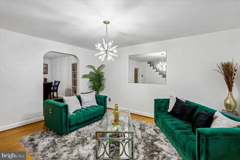 a living room with furniture and a chandelier