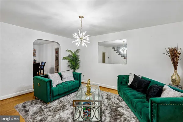 a living room with furniture and a chandelier