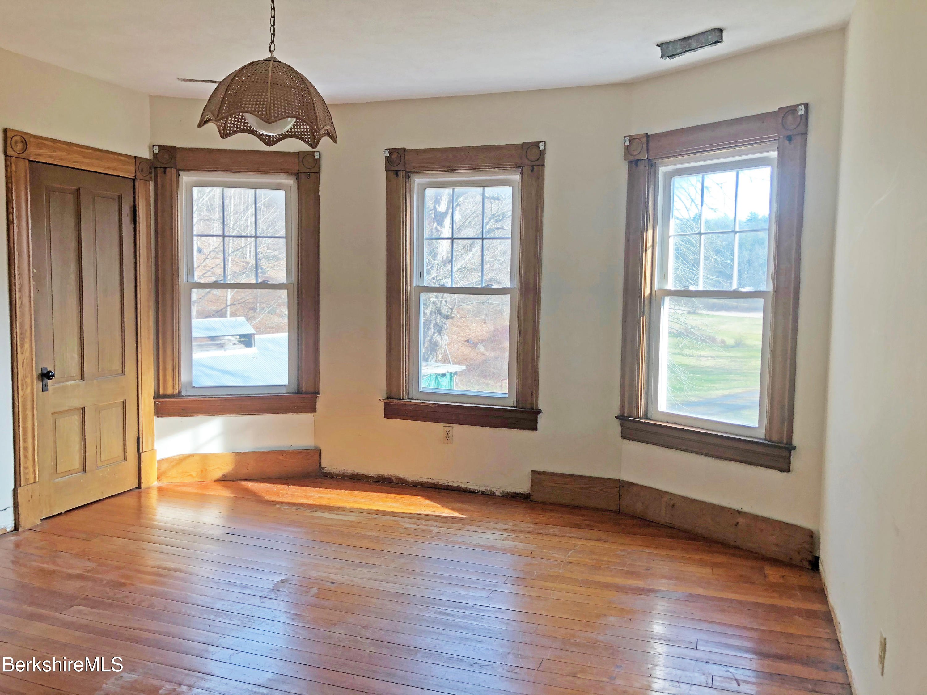 13 Old Chester Road Huntington, MA 01050 - Photo 20 of 26 a view of an empty room with wooden floor and a window