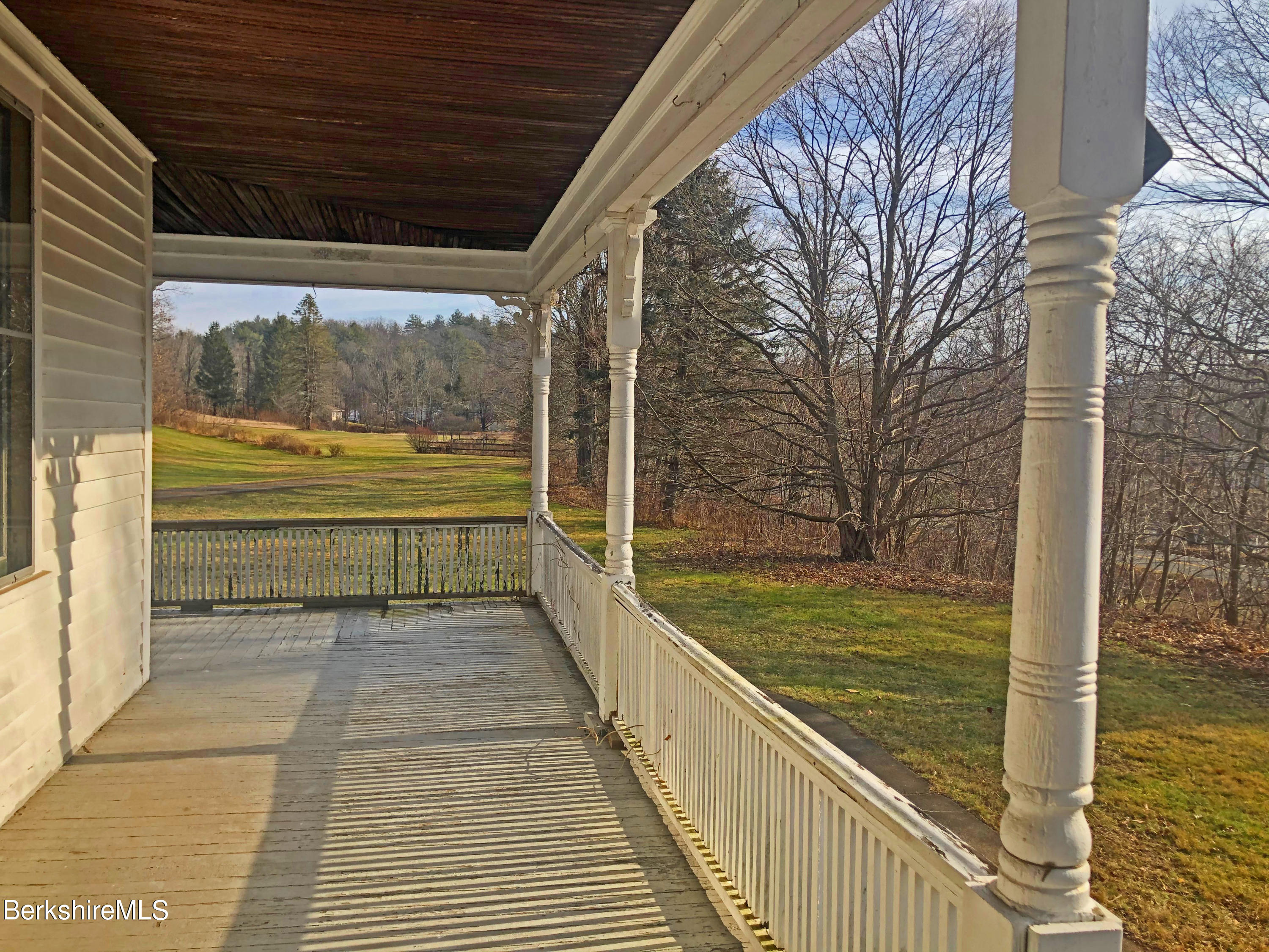 13 Old Chester Road Huntington, MA 01050 - Photo 5 of 26 a view of a balcony with floor to ceiling windows and wooden floor