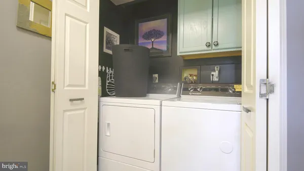 a kitchen with a refrigerator and cabinets