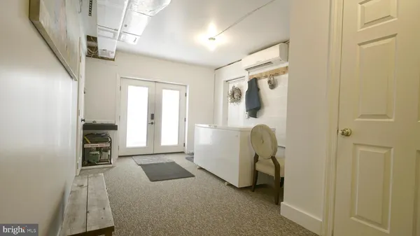 a hallway with a white stove next to a window