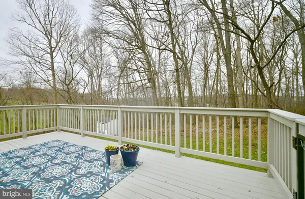 a balcony with wooden floor and fence