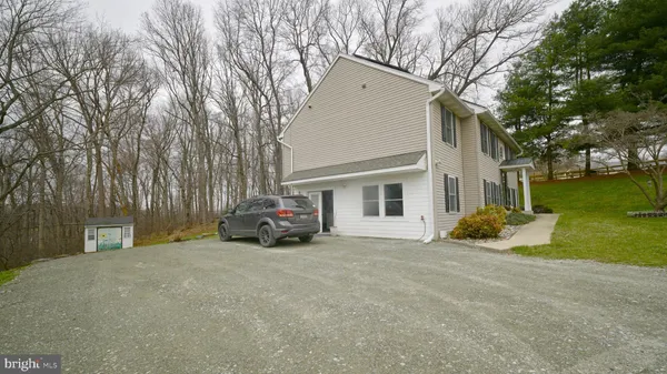 a view of a house with a patio and a yard