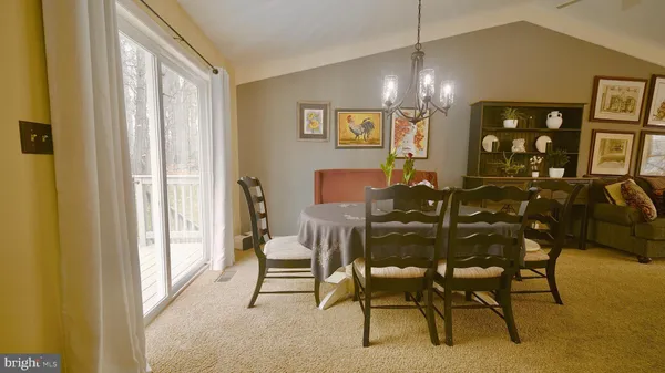 a view of a dining room with furniture and chandelier
