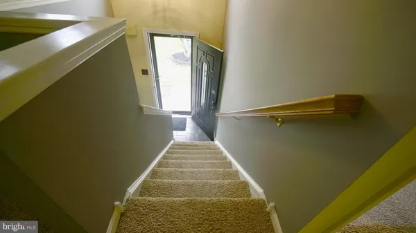 a view of a hallway with wooden floor and a hallway