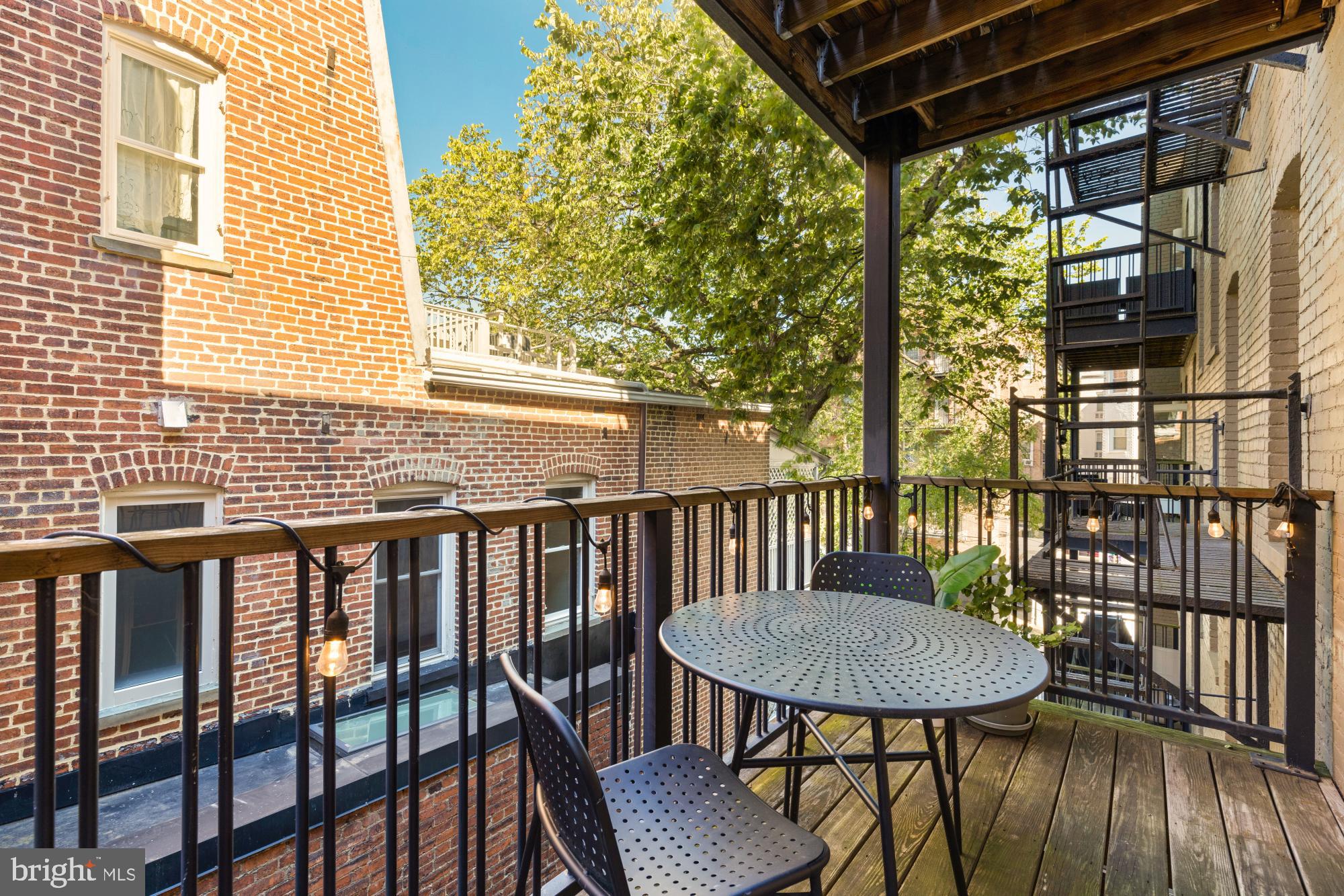 1811 Wyoming Avenue Northwest, Unit 32 Washington, DC 20009 - Photo 17 of 26 a view of a balcony with table and chairs