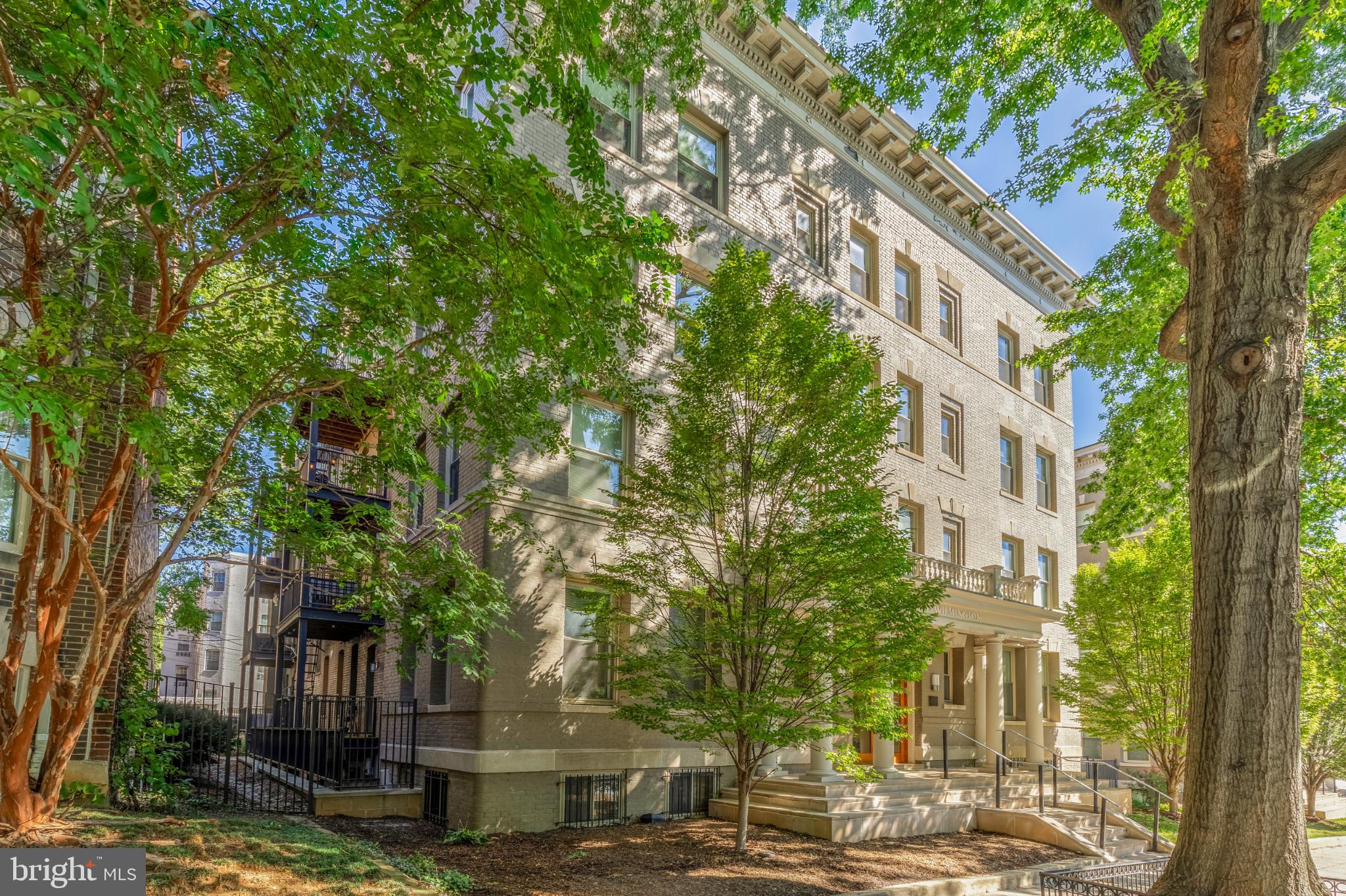 1811 Wyoming Avenue Northwest, Unit 32 Washington, DC 20009 - Photo 25 of 26 a view of a tall building with large trees