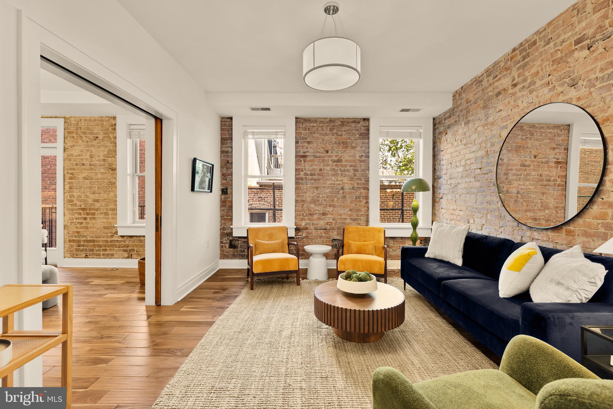 1811 Wyoming Avenue Northwest, Unit 32 Washington, DC 20009 - Photo 7 of 26 a living room with furniture and a large window