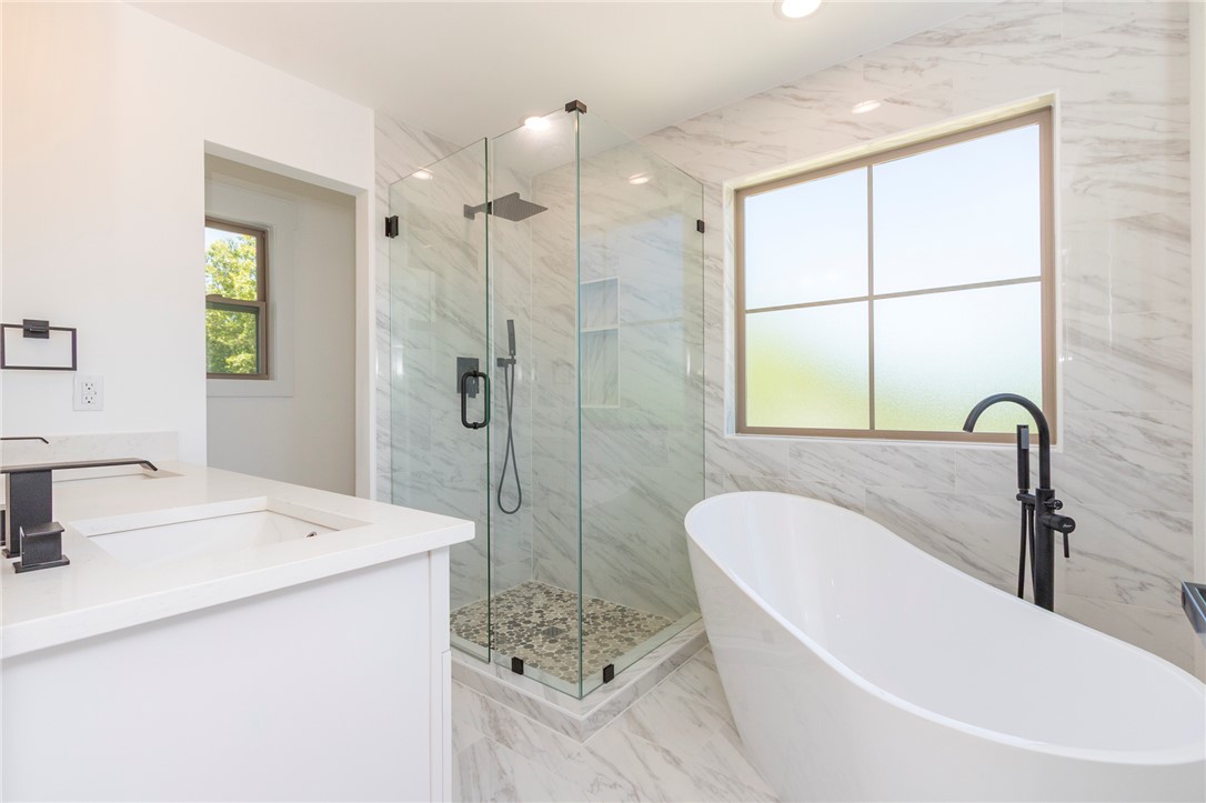 230 Hammond Circle Anderson, SC 29621 - Photo 18 of 48 This primary bathroom features a freestanding tub and a spacious glass shower, perfect for unwinding.