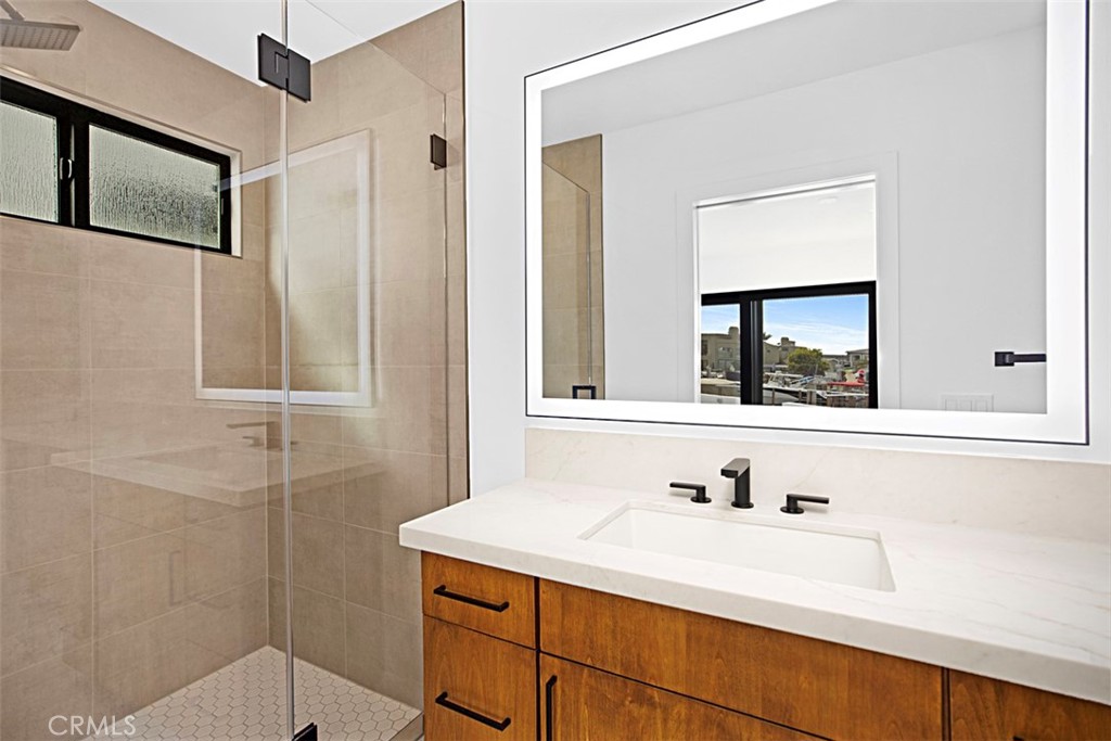 4017 Channel Place, Unit A Newport Beach, CA 92663 - Photo 13 of 18 a bathroom with a sink and a mirror
