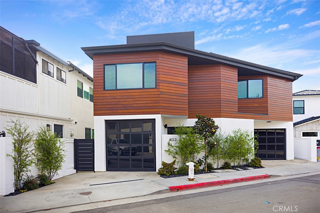 4017 Channel Place, Unit A Newport Beach, CA 92663 - Photo 2 of 18 a front view of a house with a yard