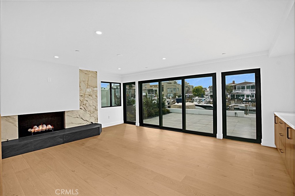 4017 Channel Place, Unit A Newport Beach, CA 92663 - Photo 5 of 18 a view of an empty room with a fireplace and a window