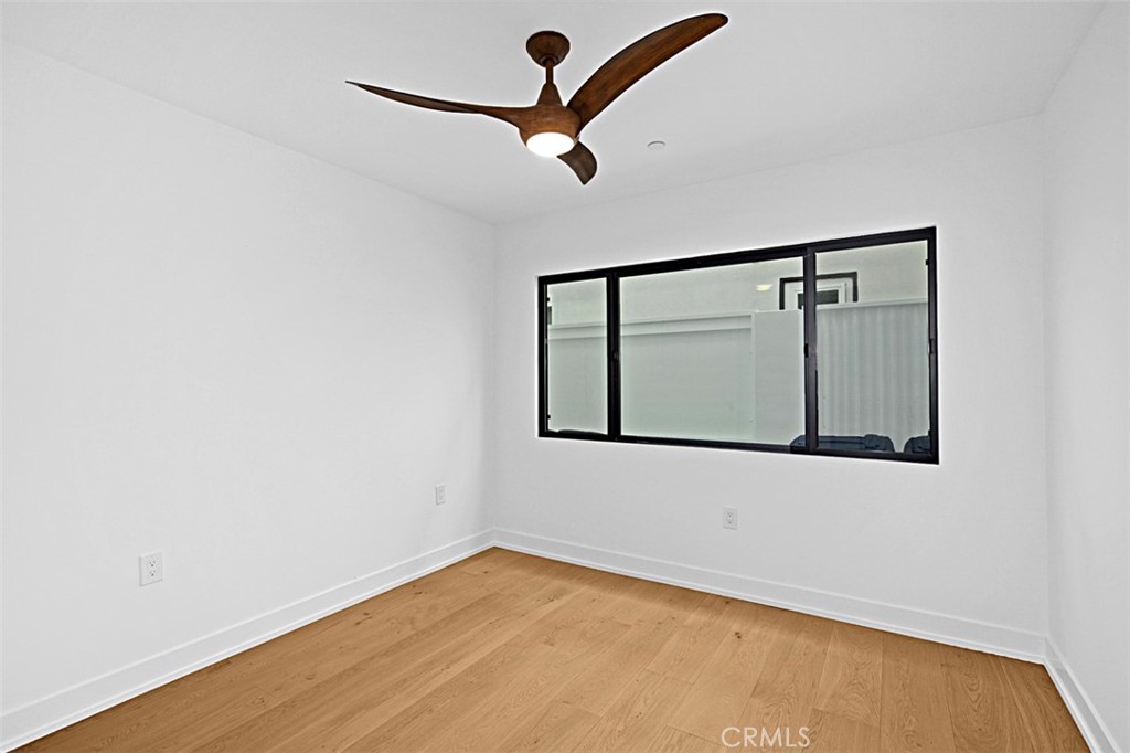 4017 Channel Place, Unit A Newport Beach, CA 92663 - Photo 6 of 18 a view of an empty room with wooden floor and a window