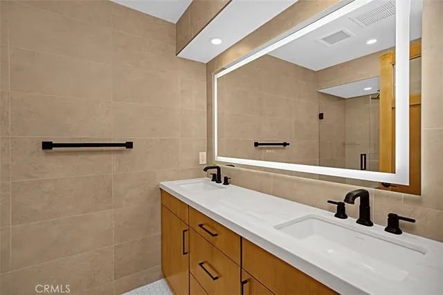 a bathroom with a double vanity sink and a mirror