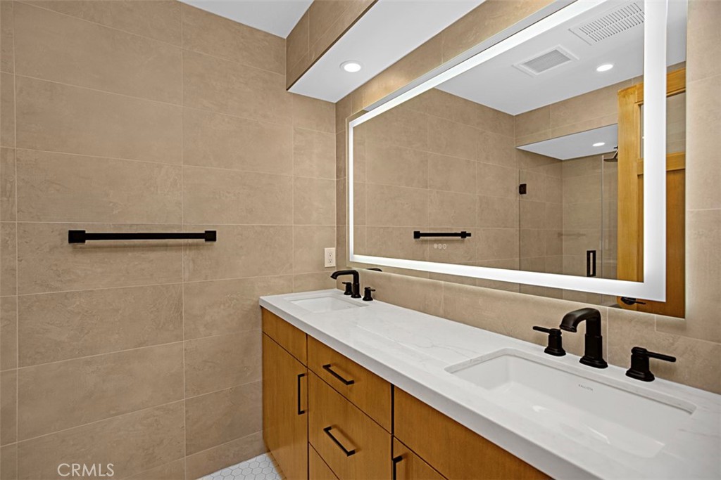 4017 Channel Place, Unit A Newport Beach, CA 92663 - Photo 8 of 18 a bathroom with a double vanity sink and a mirror