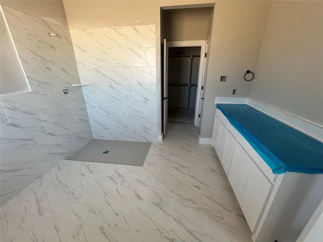 a bathroom with a bathtub and shower