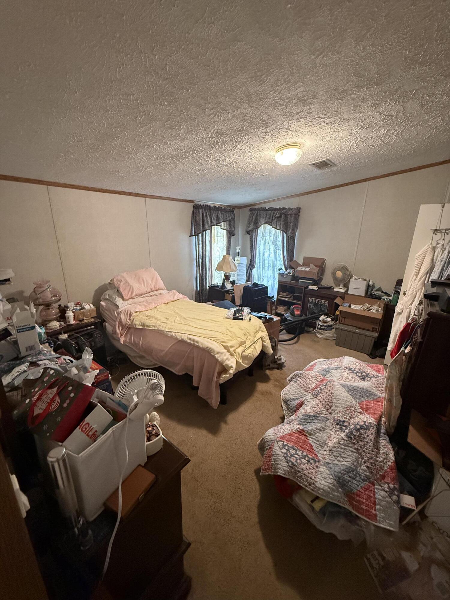 12297 Cooper Road Holt, FL 32564 - Photo 14 of 17 a bedroom with bed and window