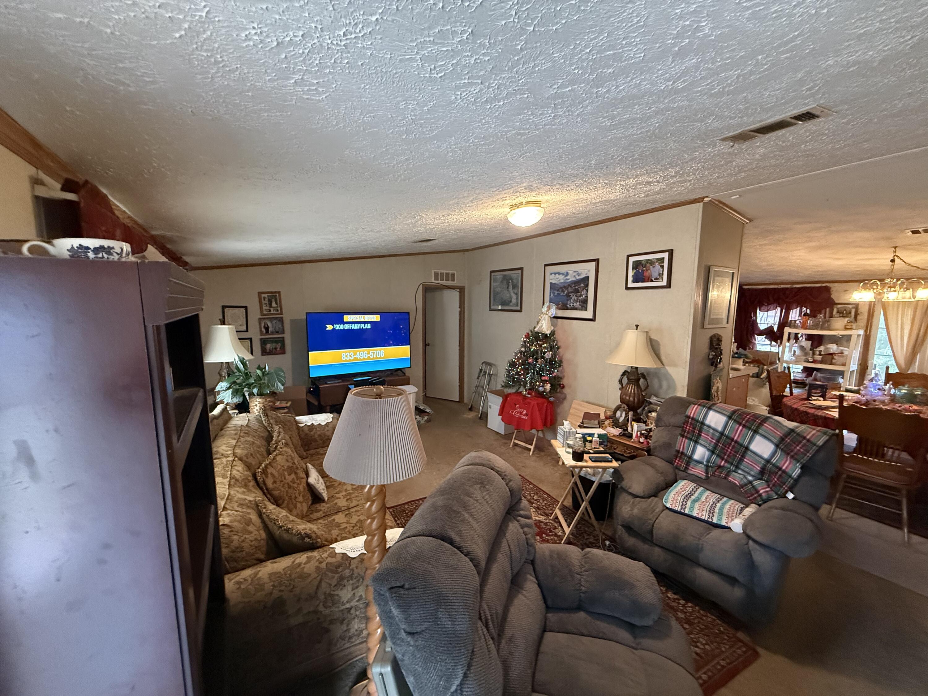 12297 Cooper Road Holt, FL 32564 - Photo 6 of 17 a living room with furniture and wooden floor
