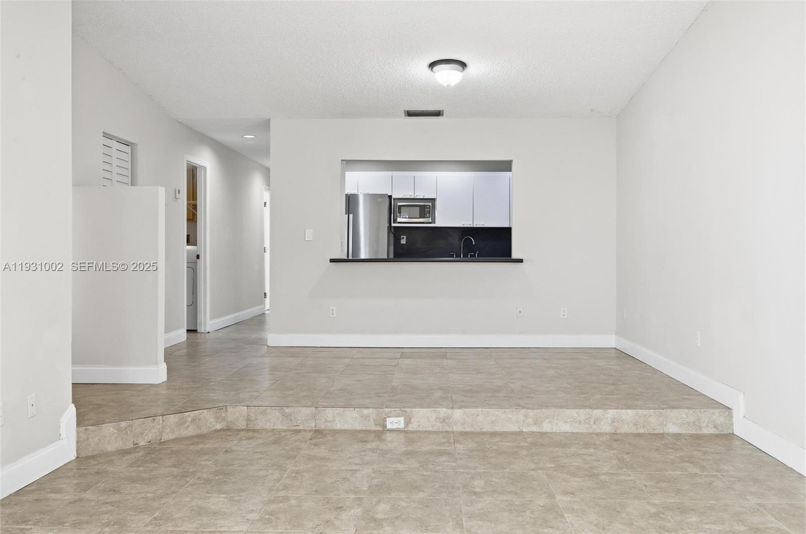 11731 Southwest 112th Terrace Miami, FL 33186 - Photo 11 of 41 a view of a refrigerator in kitchen and entryway