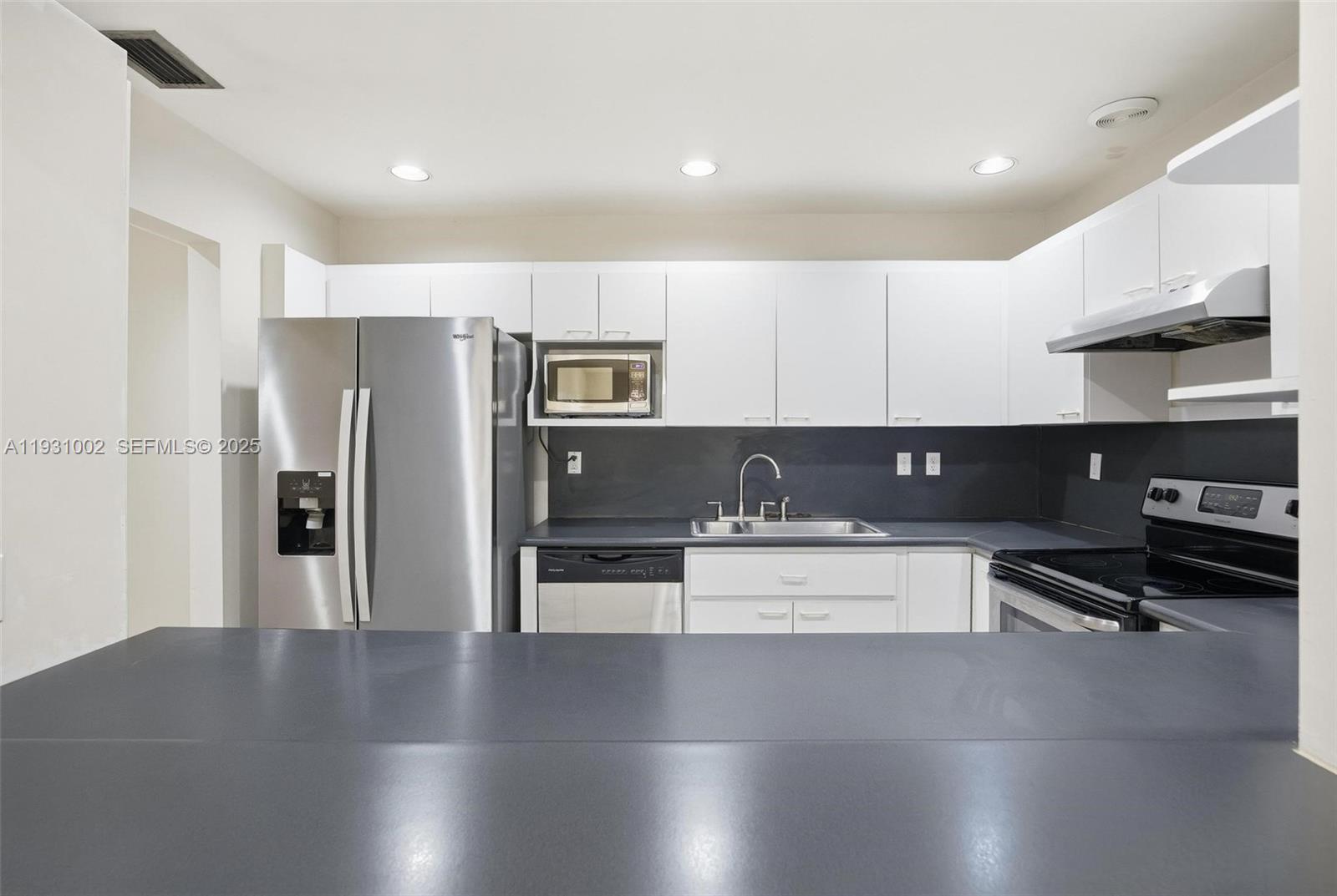 11731 Southwest 112th Terrace Miami, FL 33186 - Photo 14 of 41 a kitchen with a refrigerator and a stove top oven