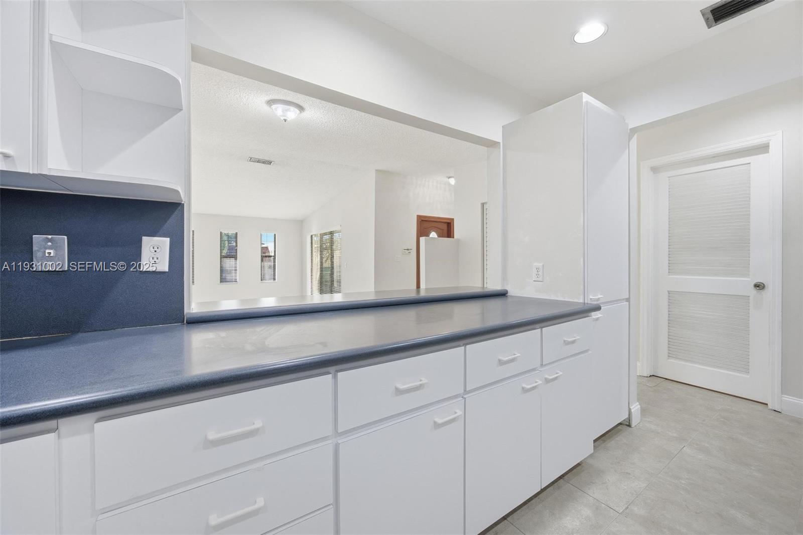 11731 Southwest 112th Terrace Miami, FL 33186 - Photo 19 of 41 a hall with cabinets and window