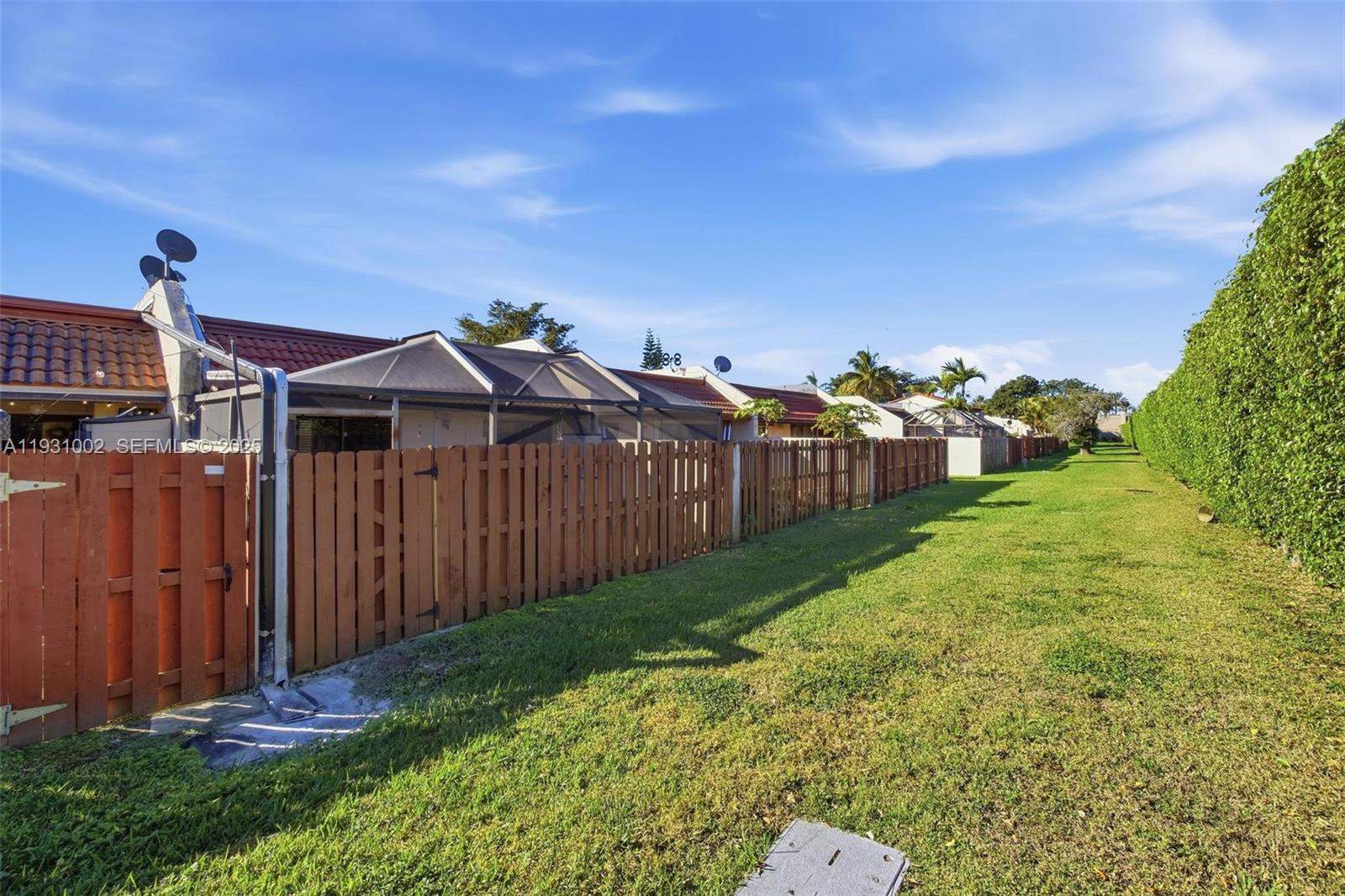 11731 Southwest 112th Terrace Miami, FL 33186 - Photo 36 of 41 a view of a house with a small yard and wooden fence