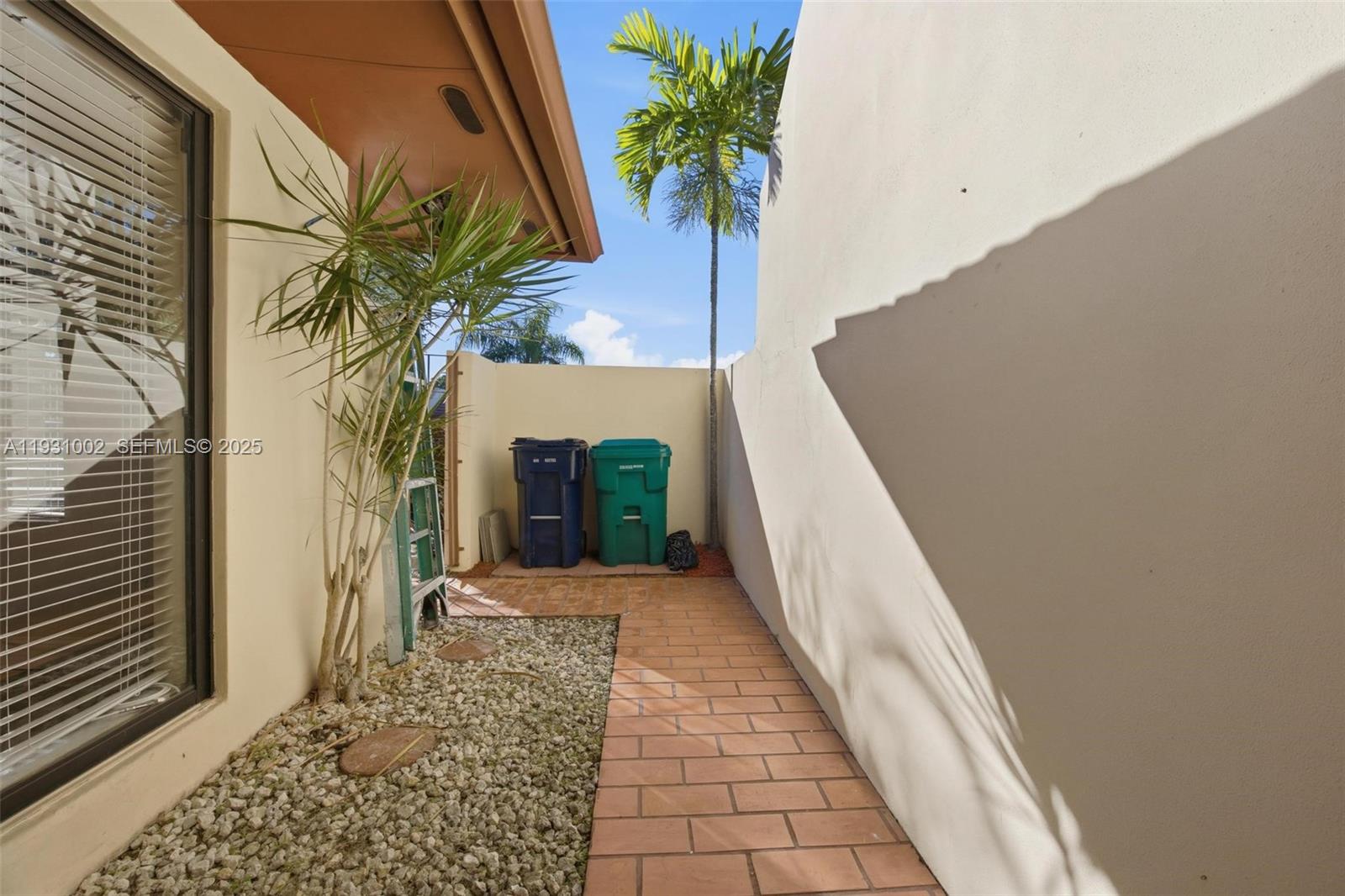 11731 Southwest 112th Terrace Miami, FL 33186 - Photo 5 of 41 a view of a hallway with wooden floor and a potted plant
